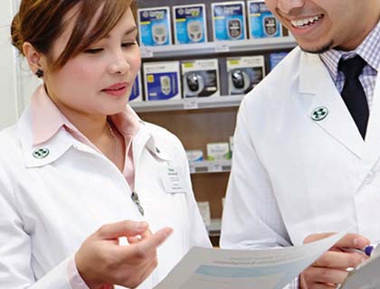Des pharmaciens discutent en regardant un document.